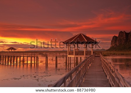 Wooden boardwalk at sunset.