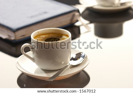 business still life: cup of coffee with writing-pad on the desk