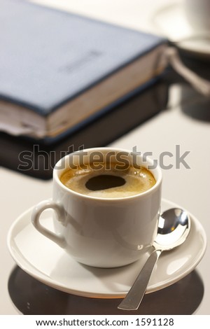 business still life: cup of coffee with writing-pad on the desk