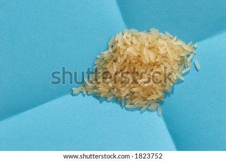 macro pic: hill of tipped rice on the blue background