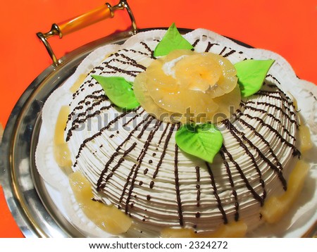 white fruit cake with pineapple decorated chocolate