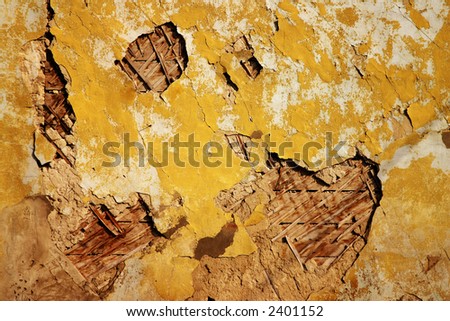 texture of old wall with a cracked golden paint. Stock Photo