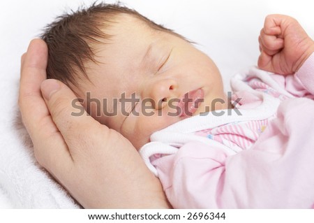 in reliable hands, sleeper baby on the mother`s palm