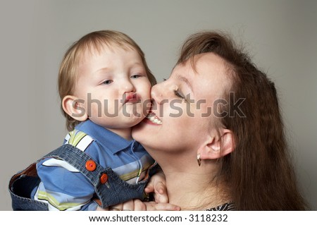 family happiness, portrait funny little boy with mother kiss