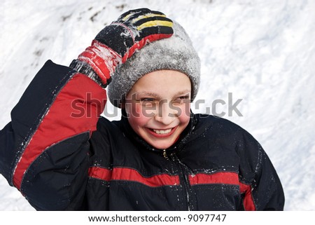 holidays theme: boy outside in a snow day