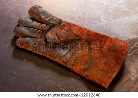 Work dirty glove on the scratch background