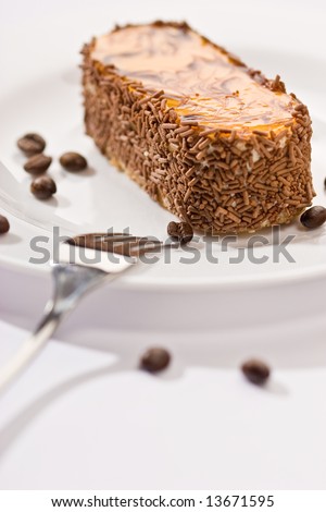 fancy cake with coffee beans over white background