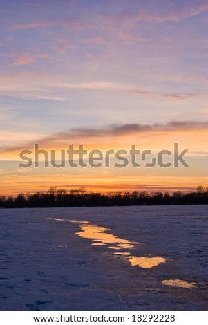 view series: cold winter sunset on the iced river