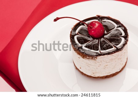 food serie: sweet fancy cake with chocolate icing and cherry