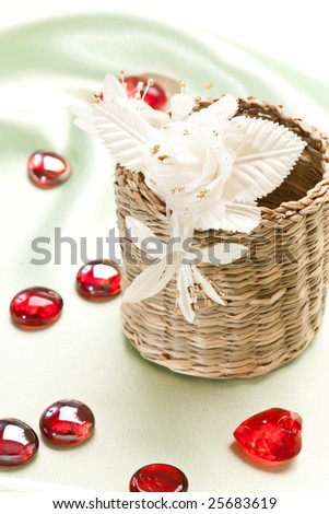 wicker box and artificial flowers on the silk