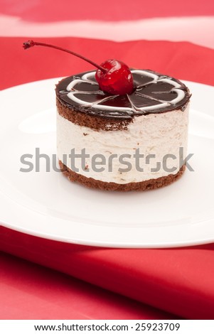 food serie: sweet fancy cake with chocolate icing and cherry