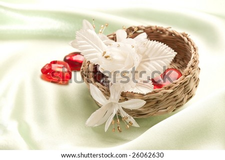 wicker box and artificial flowers on the silk