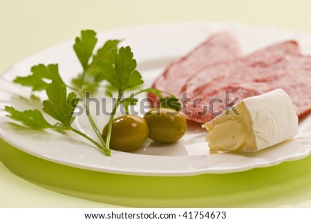 food series: salami, parsley, cheese and cucumber and olive