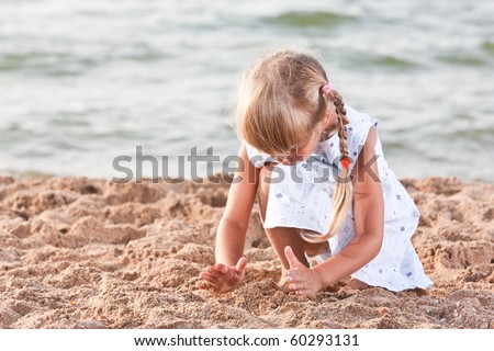people series: little girl on sea beach are play the sandy game