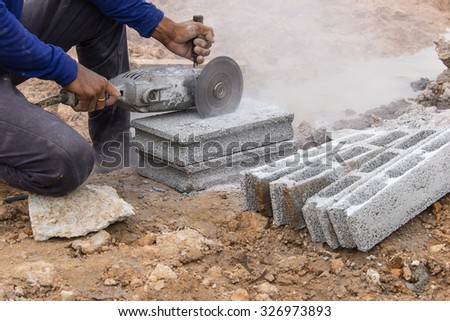 Cutting bricks in construction sites by using the tool specialists.
