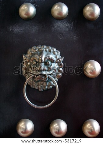 Lion's head knocker(symbolize protection) on traditional chinese door