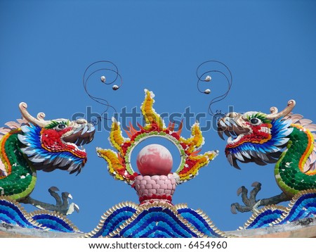 Colorful Dragons & the fire ball, on top of the roof of oriental temple