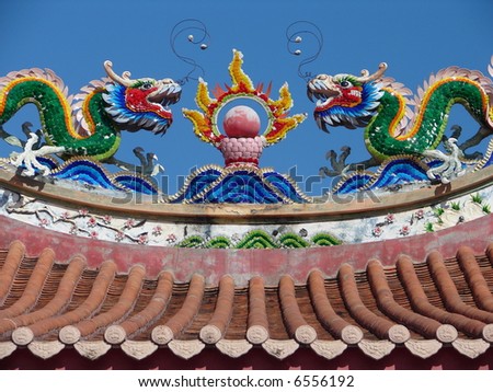 Colorful Dragons & the fire ball, on top of the roof of oriental temple