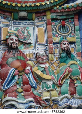 Colorful Gods carving statue on oriental temple\'s roof