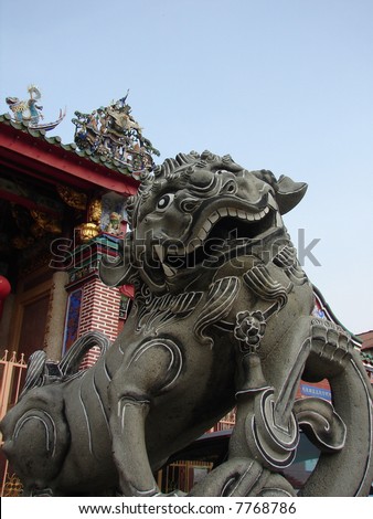 Lion statue closeup in front of the oriental temple in Asia