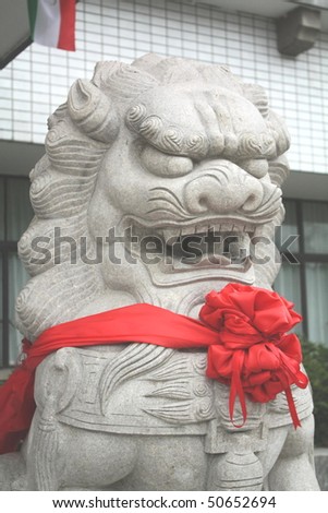 Stone lion statue at door front, Chinese people believe it can guard their house