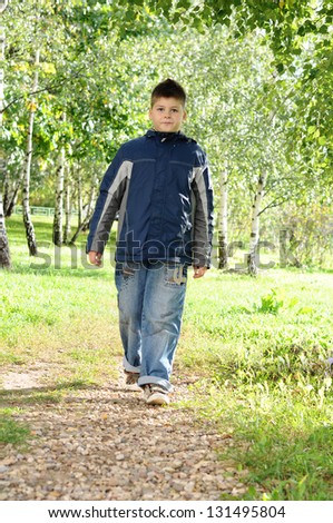 The boy is on a path in the park