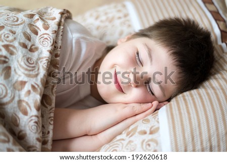 Portrait of a boy sleeping in bed day