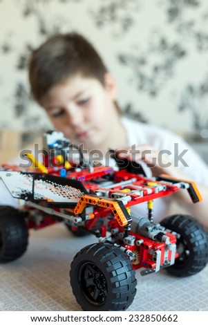 A boy plays collects from the constructor of the car
