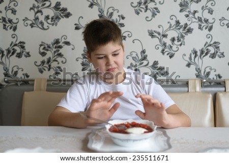 Teenager boy does not want to eat soup