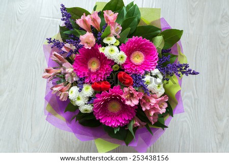 A bouquet of flowers with a gerbera