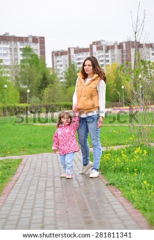 Mother And a Daughter Walking Along Path