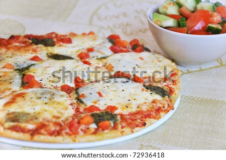 Appetizing pizza with mozzarella cheese and salad