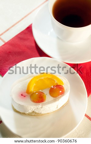 Delicious cake with fresh fruit and tea