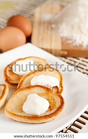 Home pancakes with sour cream, flour and eggs