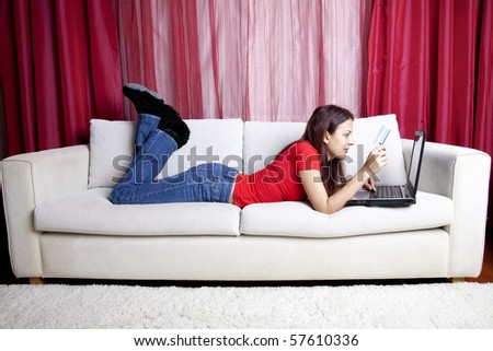 Woman Ä°s Lying On Sofa With Laptop And Credit Card