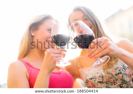 Happy women toasting with red wine