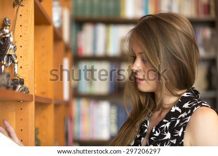 Young woman browsing library shelf