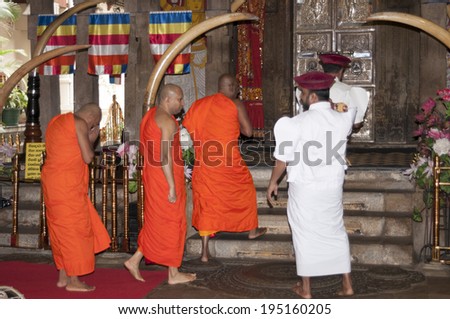 KANDY, SRI LANKA - JANUARY 29: Morning celebration in the Tooth Relic (Dalada Maligawa) on January 29, 2014 in Sri Lanka. Thousands religious people visit this greatest Buddhist landmark everyday.