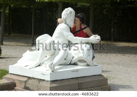 Woman hugging a huge roman statue