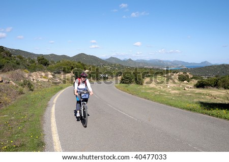 Woman climbing a hard hill with her bike