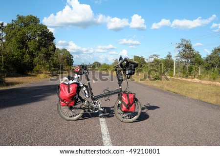 Load folding bike standing on road