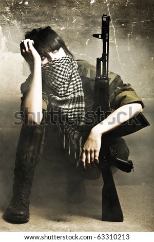 The armed Arabian woman against old wall studio photo shooting
