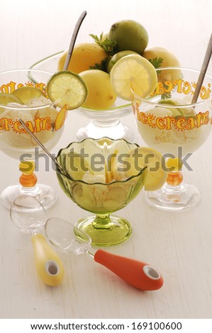 lemon and orange water with fresh lemons and green plants