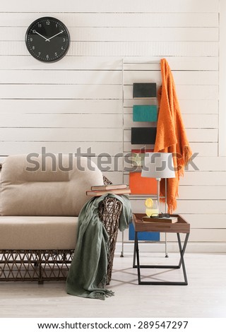 wooden wall and the wicker sofa
