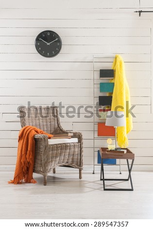 wooden wall clock on the office environment and the wicker chair