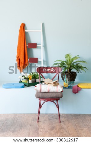 blue wall interior style with family chair