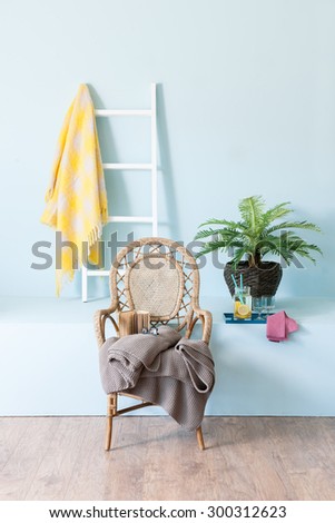 blue wall interior style with wicker sofa and  white stairs