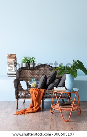 blue wall interior concept and wicker furniture