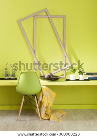 green wall interior work desk and green chair with yellow warp