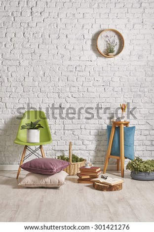 white brick wall interior, green chair with frame concept